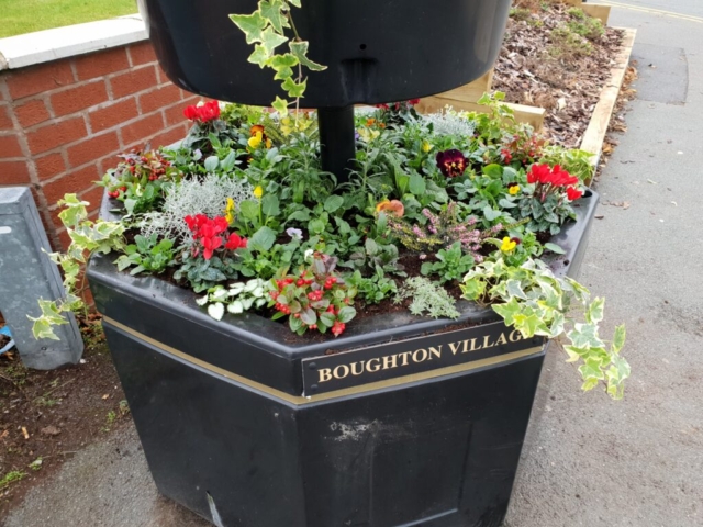 tiered pot planted with winter flowers